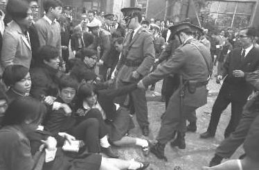写真・図版 : 校舎のバリケード封鎖解除のために出動した警官隊に、ゴボウ抜きされる日比谷高校の生徒たち ＝1968年10月28日