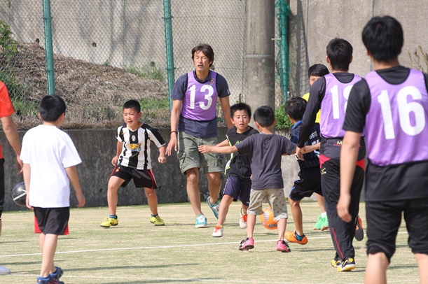 写真・図版 : ロアッソ熊本の巻誠一郎（13）らとサッカーを楽しむ避難所の子どもたち＝2016年4月19日、熊本県益城町の阿蘇熊本空港ホテルエミナース