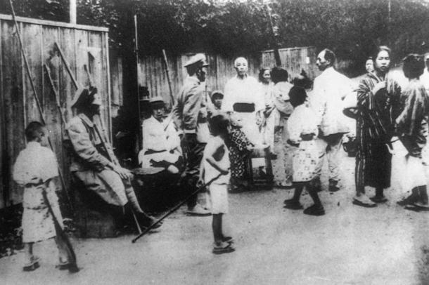 写真・図版 : 東京・麻布周辺で撮影された自警団。竹やりかこん棒らしきものを持つ子供もいる。軍服を着ているのは在郷軍人＝1923年9月