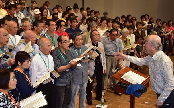 写真・図版 : 池辺晋一郎さん（右）の指揮で「731部隊」を題材にした合唱のリハーサルをする合唱団員＝2018年6月23日、富山県射水市