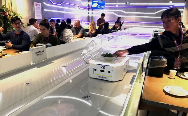 写真・図版 : アリババが開発したロボット・レストラン（上海市内）。注文した料理がテーブルまで自動的に届く。さながら巨大な回転ずしという感じだ