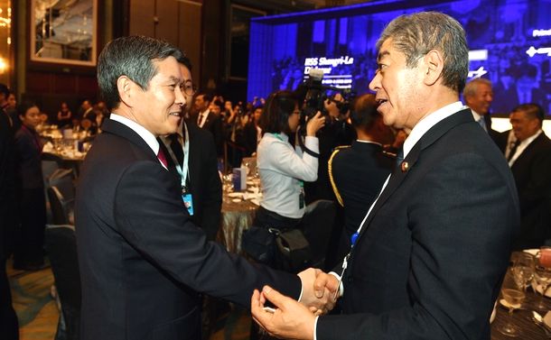 写真・図版 : シンガポールで開かれたアジア安全保障会議の夕食会で握手する岩屋毅防衛相（右）と韓国の鄭景斗国防相。岩屋氏が笑顔で握手を交わしたことに対し、自民党内から批判が出た＝2019年5月31日、韓国国防省提供 