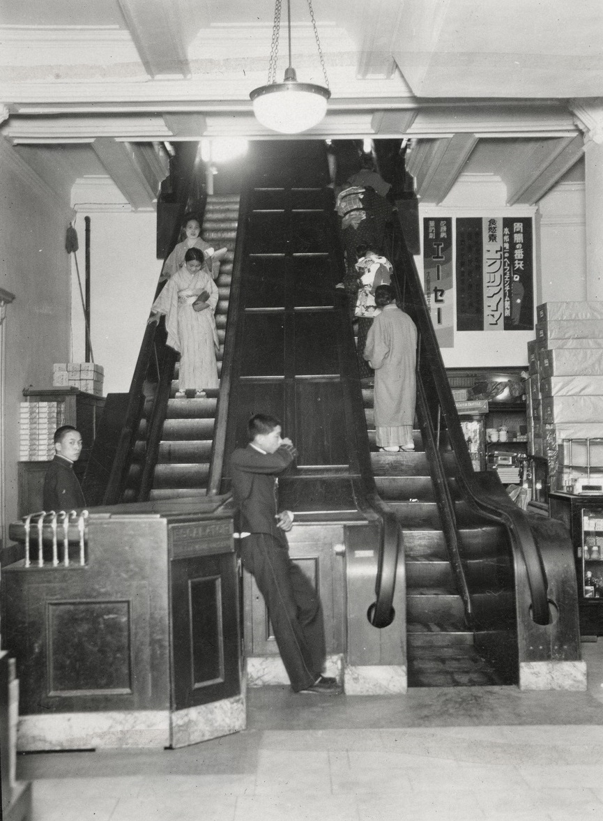 写真・図版 : 1930年に撮影された大阪・三越百貨店のエスカレーター。１人分の幅しかなく、当然みな歩かずに立って乗っていた