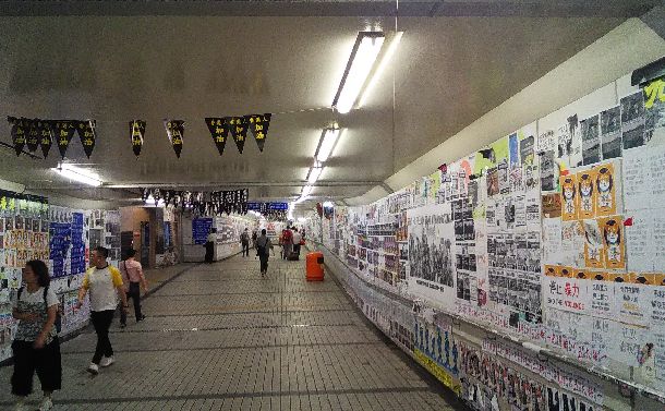 写真・図版 : 地下道にびっしりと張り詰められた民主化を求めるポスター＝2019年10月1日、香港の九竜半島尖沙咀、筆者撮影