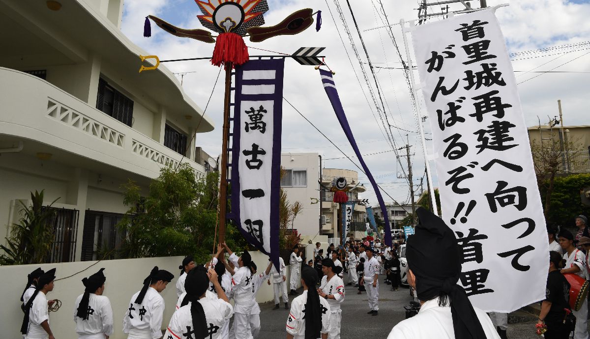 写真・図版 : 焼失した首里城の復興願を願う「旗頭」が「サーサー」の掛け声とともに担がれ、大きく揺れていた＝2019年11月3日、那覇市首里大中町 
