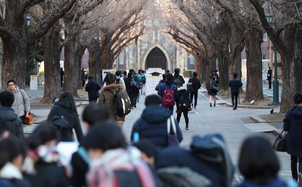写真・図版 : センター試験の会場に向かう受験生ら＝2019年1月19日、東京大学