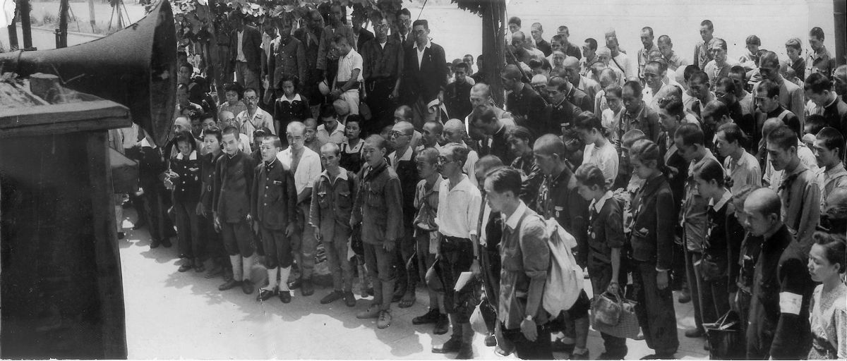 写真・図版 : 1945年8月15日、終戦を告げる玉音放送に聴き入る人たち＝大阪・梅田の曽根崎警察署前。朝日新聞社