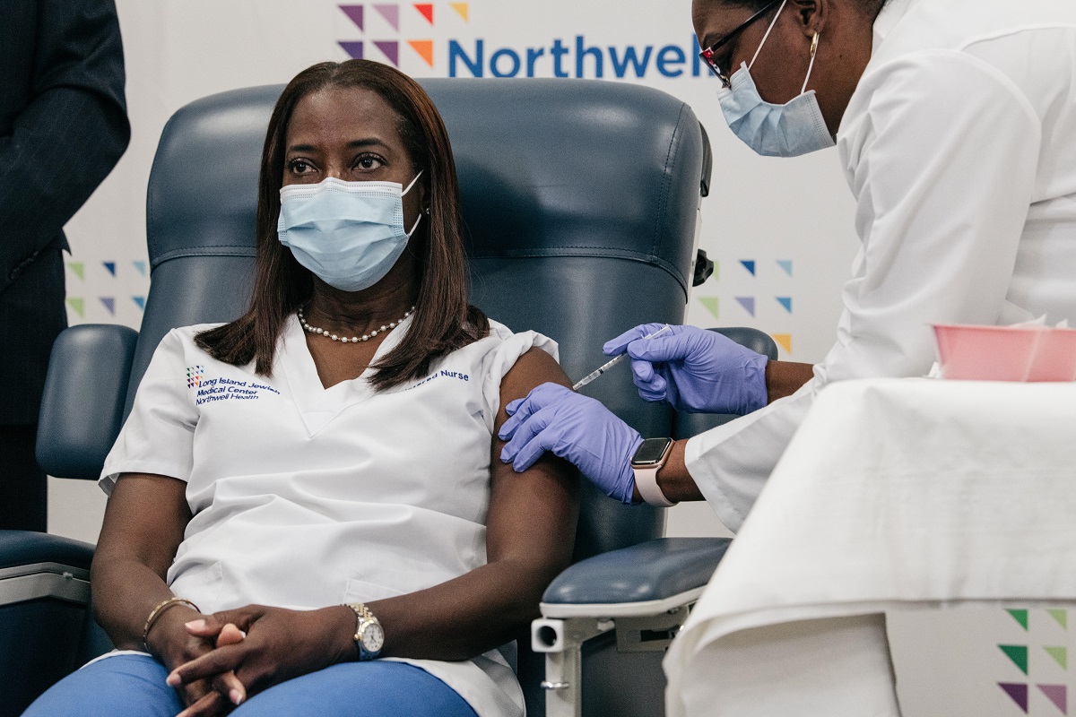 写真・図版 : ニューヨーク市で最初に新型コロナウイルスのワクチンを接種した女性看護師のサンドラ・リンゼイさん=2020年12月14日、ニューヨーク州知事室提供