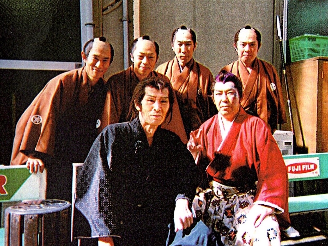 写真・図版 : 京撮（東映京都撮影所）で共演の俳優たちに囲まれた福本さん（前列左）