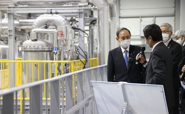 写真・図版 : 福島水素エネルギー研究フィールドの水素製造施設を視察する菅義偉首相（左）＝2021年3月6日、福島県浪江町