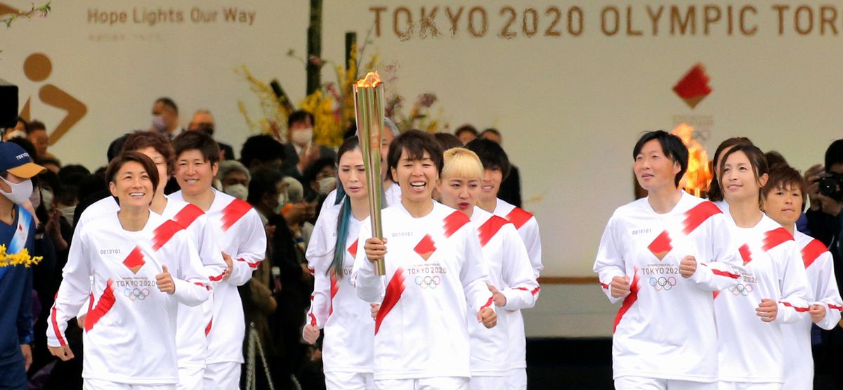 写真・図版 : コロナ禍が収束しないまま、東京五輪の聖火リレーが3月25日、東日本大震災から10年を迎えた被災地の福島県から始まった。第1走者は、震災の年に女子サッカーワールドカップで優勝した「なでしこジャパン」のメンバーら16人が務めた＝2021年3月25日午前9時42分、福島県のJヴィレッジ