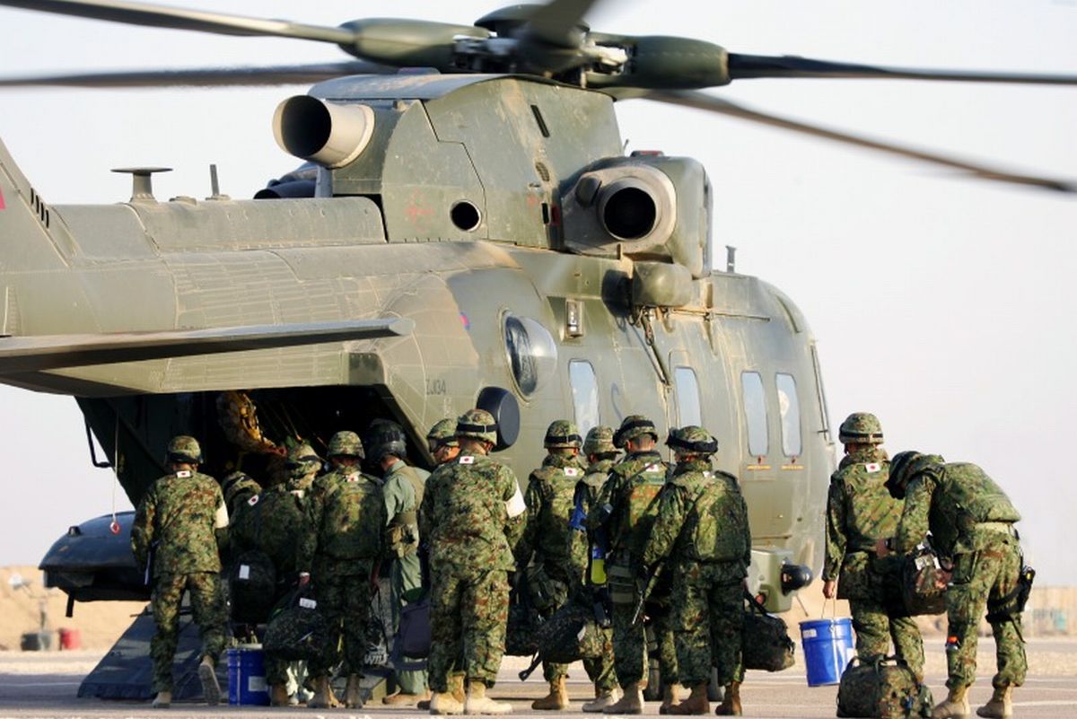 写真・図版 : 2006年、英軍ヘリに乗り込みサマワを離れる陸上自衛隊の派遣部隊＝陸自提供