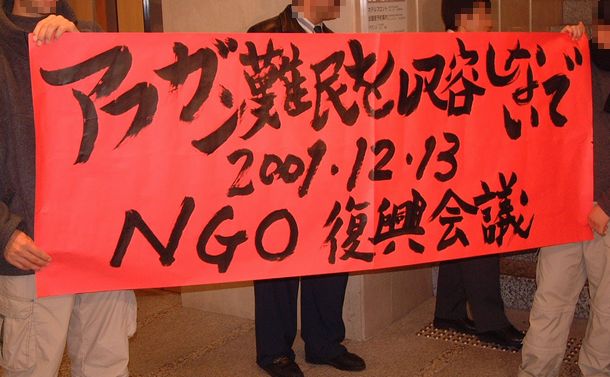 写真・図版 : アフガニスタン復興支援のためのＮＧＯの国際会議がホテルで、「アフガン難民を収容しないで」と記した横断幕を掲げるアフガンの人たち＝2001年12月13日、東京都千代田区