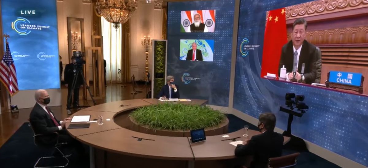 写真・図版 : 気候変動サミットで中国の習近平国家主席が映し出された画面（右）を見る米国のバイデン大統領（左）＝2021年4月22日、米国務省ウェブサイトの中継動画から