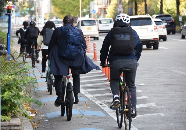 通勤時間帯の自転車専用レーン。ヘルメットの着用者はまばらだった＝２０２１年１１月８日午前８時７分、名古屋市中区の桜通大津交差点